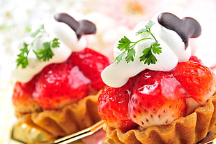 two Strawberry on top with cream pastries