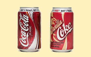 two Coca-Cola and Vanilla Coke cans