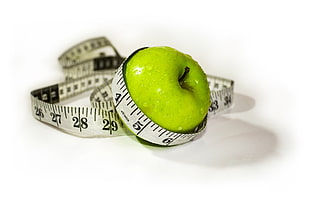 green apple wrapped of white tape measure HD wallpaper