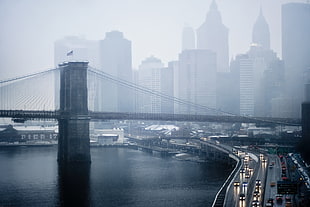 Brooklyn Bridge surrounded of fogs during daytime