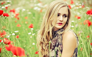 woman wearing black and grey sleeveless tops on red poppy flower field during daytime
