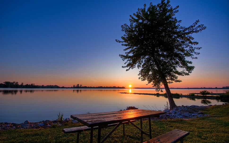 photo of rectangular brown picnic table near lake during sunset HD wallpaper