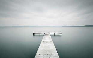 photo of wooden dock on calm body of water