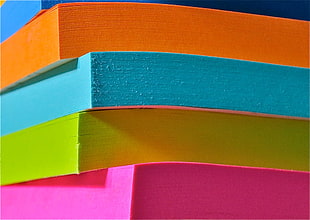 close photo of pile of colored papers