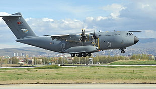 photo of gray cargo plane during day time