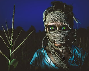 person holding rice and burlap mask, horror, Bryan McGowan, green eyes, scarecrows