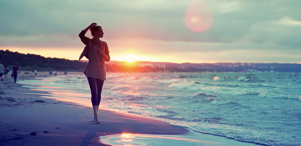 woman walking on seashore HD wallpaper