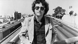 man in blazer and sunglasses on bridge