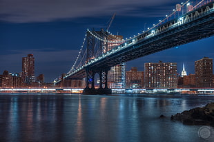 painting of Manhattan Bridge with lights during nighttime HD wallpaper
