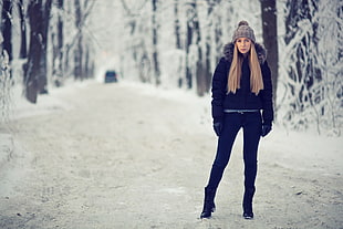 woman standing on snowfield near trees HD wallpaper