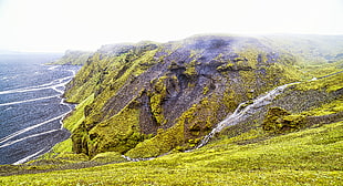 green mountains beside sea HD wallpaper