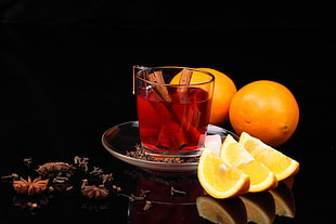 drink on clear glass cup with orange fruits on the side