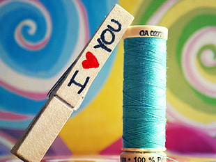i heart you printed wooden decor leaning on blue threadroll