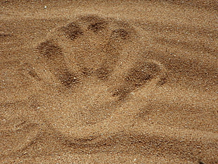 person's handprint in sand HD wallpaper