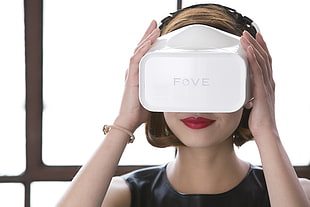 woman wearing black top and using VR goggles
