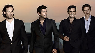 four men's wearing black formal suit jackets