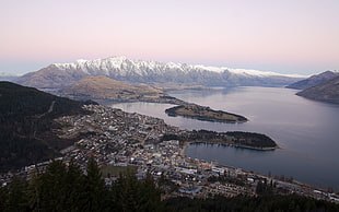 aerial photo of village beside lake and mountains, cityscape, valley