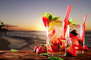 sliced strawberries on two pint glasses with red straws HD wallpaper