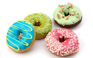 four assorted flavor donuts