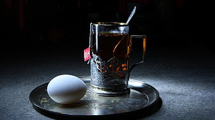 grey mug and white egg on round grey stainless tray