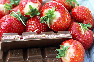 close up photograph of strawberries with chocolate bar