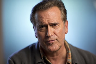 portrait photo of man wearing gray shirt