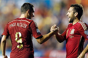 two men's red soccer shirts, Paco Alcacer, holding hands, footballers, men