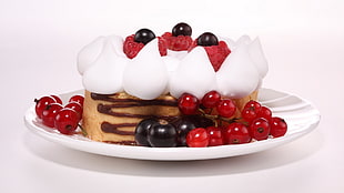 round brown cake with black grapes on top