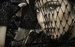 woman with black mesh on face