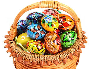 assorted color organic eggs in brown wooden picnic basket