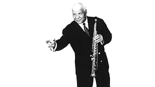 man wearing black formal wear and holding a clarinet