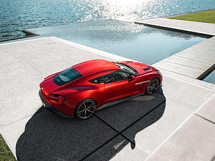 red sports coupe near body of water digital wallpaper