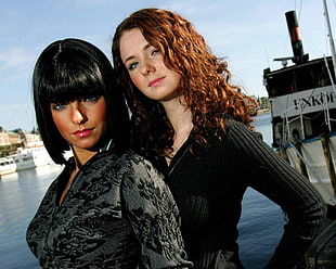 two women wearing black top facing camera HD wallpaper