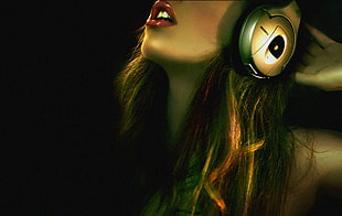 woman using gray headphones