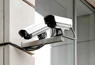 two white surveillance cameras