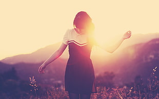 photo of woman wearing white and black dress during golden hour