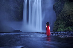 woman standing near water falls photography HD wallpaper