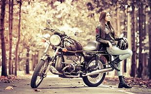woman leaning on standard motorcycle