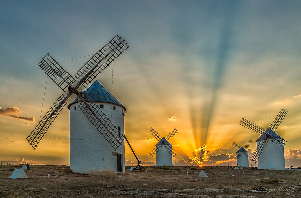 four white concrete windmills at during sunset HD wallpaper