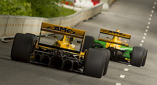 two yellow F1 cars, race cars, Formula 1, race tracks