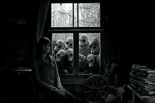 monochrome photo of woman near window with masked people