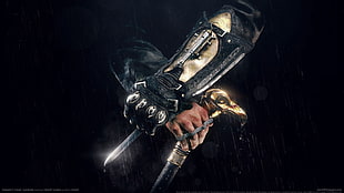 man in black arm band holding black fantasy sword