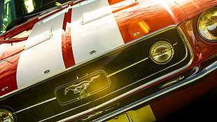 red and white Ford Mustang in close up photo