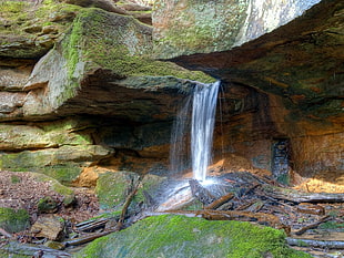 waterfalls flowing on mossy brown rock formation closeup photo
