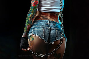 woman wearing denim daisy dukes with assorted tattoos