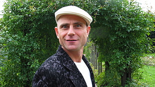 man wearing white patrol cap standing and smiling
