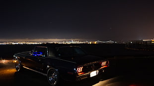 black classic Ford Mustang at night