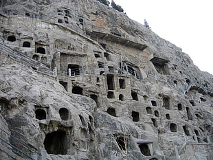 gray rock cave houses HD wallpaper