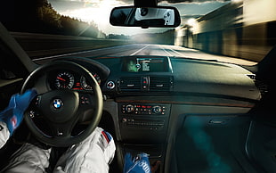 person driving black BMW car HD wallpaper