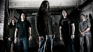 five members of rock band standing